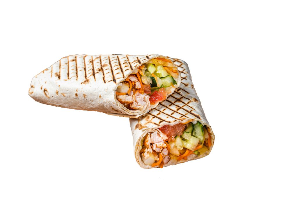 Shawarma durum doner kebab with meat and vegetable salad. Isolated on white background.